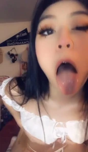 petite asian teen sticks tongue out for you