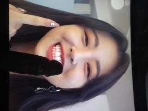 Itzy Yuna con un pene negro en la cara