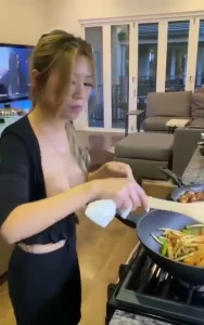 Asian milf cooks topless