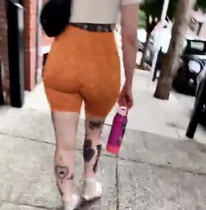 Candid goth chick booty cheeks in orange spandex shorts