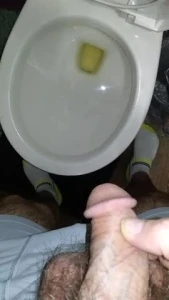 Closeup of piss into toilet